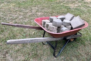 lot 143 image: Outdoor Patio Cresent Concrete Blocks and Wheelbarrow...