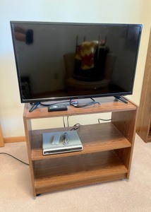 lot 65 image: Insignia 32 inch TV, RCA DVD player and stand with remotes