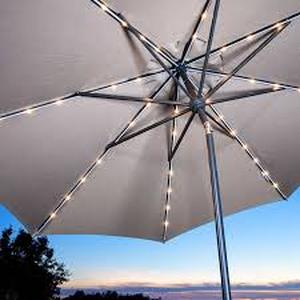 lot 4 image: Sunvilla 10 Round Solar LED Market Umbrella-Remy Fawn Color