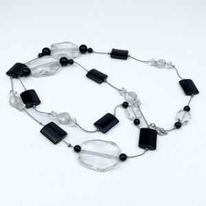 Stylish opera length, Glass Bead White Base Metal Station Necklace. Black And Colorless Beads.