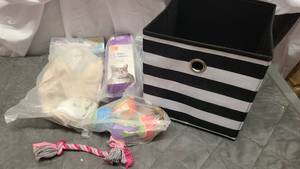 Totes of pet toys and cat equipment.