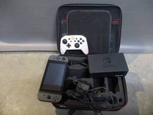 lot 25 image: Nintendo Switch and Travel Case