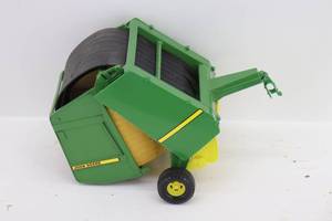 lot 12 image: John Deere Baler w Hay Bale