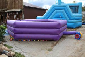 lot 938 image: Bounce House  Gaga Ball Pit with 13,000 Plastic Balls, Tarp, Tool King Air Eagle Blower and Stakes