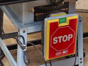 lot 17 image: Delta 10 Woodworking Contractors Table Saw on a Rolling Stand