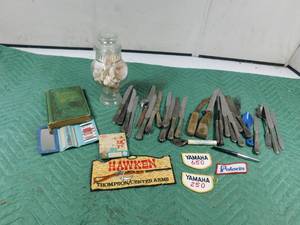 lot 38 image: Antique 1878 Uncle Tom book, silver silverware, patches, advertised sewing kit, Amico safety fuse lamps, shells and advertised bottle opener