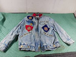 lot 51 image: jean jacket with military pins and buttons