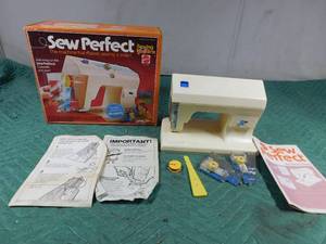 lot 66 image: Vintage 1976 Sew perfect sewing machine with sewing cassettes and instructions and needle threader