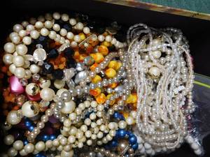 lot 93 image: Photo box full of beaded necklaces