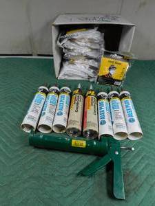 lot 293 image: Concrete crack sealant, silicone, caulking gun and box of cloth face masks