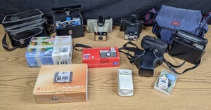 lot 58 image: Canon Powershot A570 IS Digital Camera, Canon Powershot A60,  Agfacolor Isoflash Rapid C, Varizoom, Polaroid Land Camera Big Swinger 3000,  Polaroid Square Shooter 2, Asahi Pentax, & More