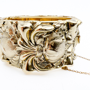 lot 59 image: Ornate floral pattern, Unknown Maker, Yellow Plated Brass Hinged Bangle.