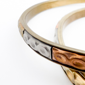 lot 91 image: Pair of, Unknown Maker, Copper, Brass And White Base Metal Slip-On Bangle Bracelet.