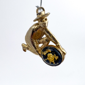 lot 61 image: Man panning for gold, Unknown Maker, Solid Cast Charm. With Resin Cabochon