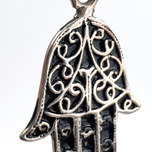 lot 102 image: Hamsa (Hand of Fatima), Unknown Maker, Sterling Silver One-Part Stamped Charm.