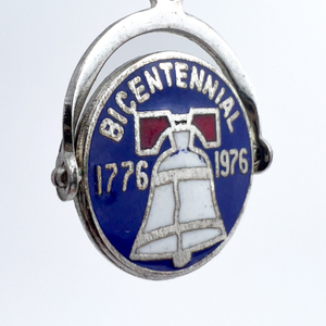 lot 109 image: Bicentennial 1776-1976, Elco  Rotating mechanical Sterling Silver Enamel Charm.