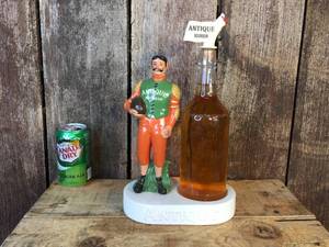 lot 25 image: Vintage Antique Bourbon Football Bottle Display
