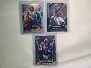 lot 217 image: Lot of 3 Vikings Adam Thielen 2020 Optic No. 65, Teddy Bridgewater Rookie 2014 Topps Chrome No. 5 (Jersey Number), Irv Smith Rookie Panini Prizm No. 366
