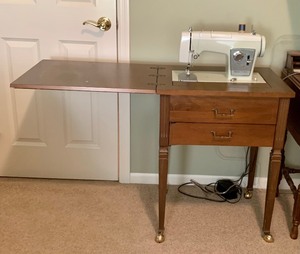lot 57 image: Popup Sewing Machine in Beautiful Wood Cabinet