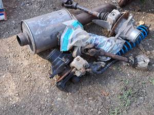 lot 877 image: ATV Parts - Muffler, Drive Shafts, Brake CaliperRotor, Spring