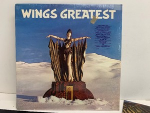 lot 23 image: Paul McCartney Wings Greatest Vinyl Record w Poster