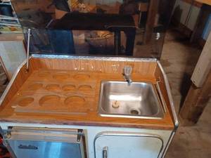 Icer-Ette Stainless Steel Ice Maker by Raritan Engineering in an Attractive Marine Sink Base Cabinet with Tinted Hinged Top and Storage Area