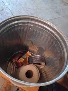 Metal Garbage Can with Lid Containing New Lawn Edging