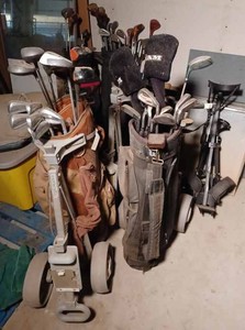 Five Golf Bags of Clubs and 4 Golf Bag Carts