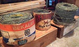New Roll of Bekaert 15.5 Gauge 2-Strand Barbed Wire, a New Partial Roll of Red Brand 15.5 Gauge 2-Point Barbed Wire, and a Large unmarked