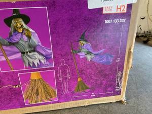 lot 11 image: Home Accents Holiday 12 ft. Giant-Sized Animated Hovering Witch Halloween Decoration