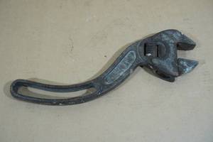 lot 66 image: Antique Curved Adjustable Wrench