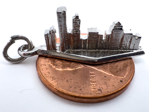 lot 74 image: Chicago Skyline, Kinney Sterling Silver Charm.