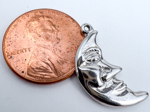 lot 81 image: Man in the Moon, Rembrandt Charms - half moon with face Sterling Silver Charm.