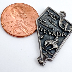 lot 131 image: Nevada State charm with Heavy Relief Lettering, Elco Sterling Silver Charm.