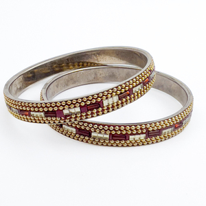 lot 229 image: Pair of Slip-On Bangle Bracelets. Enameled (Resin). Central Row Of Beads Embedded Into Red Enamel.