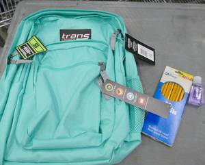 lot 77 image: Teal colored backpack and pack of pencils
