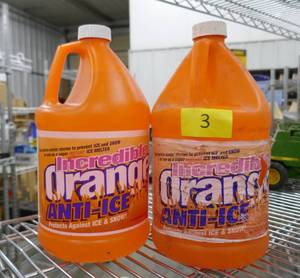 lot 139 image: Two 1 gallon jugs of Orange Ice Melt for your sidewalk