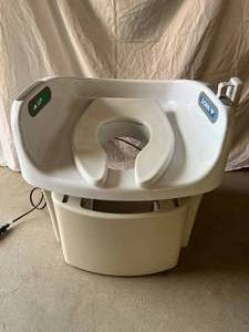 lot 41 image: WOW MSRP $3500 LiftSeat LS300-P-111 Over The Toilet Powered Lifting Commode Toilet Seat With Remote Plus Inside Arm UpDown Lifting Switches - Great Working Condition