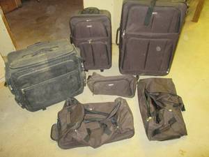 lot 77 image: Nice assortment of black rolling Duffle Bags