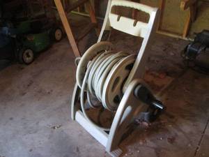 lot 210 image: Suncast hose reel with garden hose