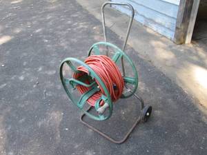 lot 228 image: Metal hose reel used with extension cords