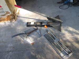 lot 8 image: 2-Tile cutters along with a siding cutter