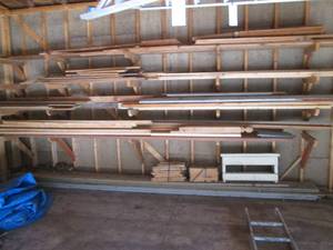 lot 600 image: Wall full of wood, includes 2x4, trim, rough, siding and a couple long treated deck planks