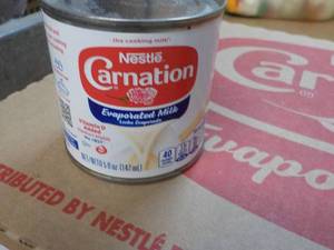lot 128 image: 24 ct 5 oz Cans Nestles Carnation E...