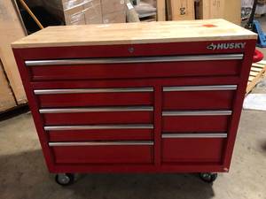 lot 17 image: Husky 42 in. W x 18.1 in. D 8-Drawer Red Mobile Workbench Cabinet with Solid Wood Top Customer Returns See Pictures