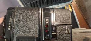 lot 27 image: Vintage Nikon 35-millimeter Film Camera, Nikon Motor Drive, MD-4. 406945 Complete with Vivitar Flash Attachment and Film In Case