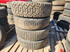 Lot of (4) Bridgestone W910 24570R19.5 Skid Loader Studless Snow Tires with 8-lug Rims