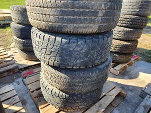 Lot of (4) Goodyear Wrangler SR-A P27565R18-114T Skid Loader Tires with 8-lug Rims