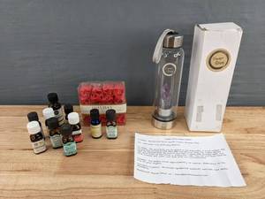 lot 211 image: Home Spa Items Essential Oils, Scented Soap Petals, and Crystal Elixir Water Bottle D