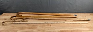 lot 227 image: A Collection Walking Canes and a Yard Stick D